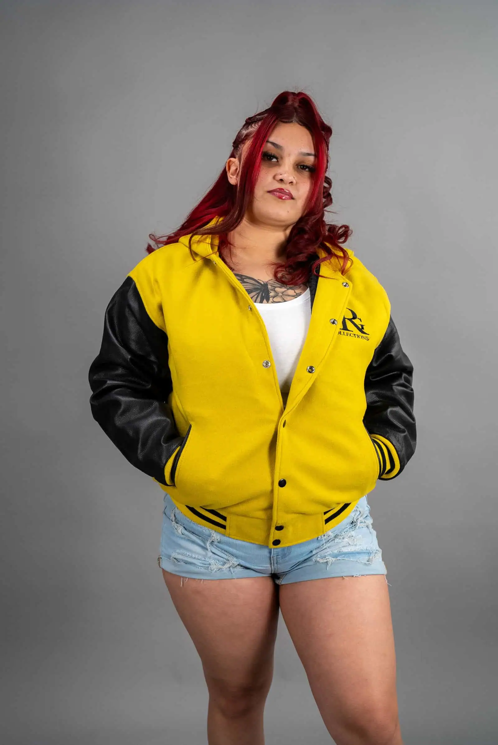 Reign Gear women's yellow and black water-repellent detachable hooded varsity jacket.