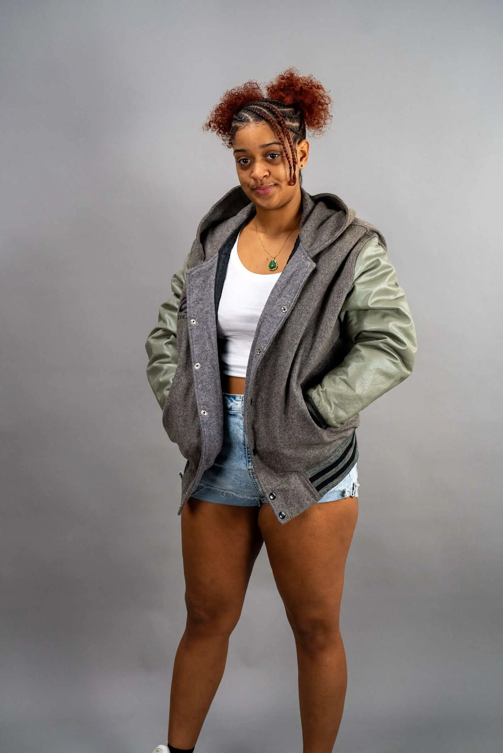 Reign Gear women's gray and olive water-repellent hooded varsity jacket.